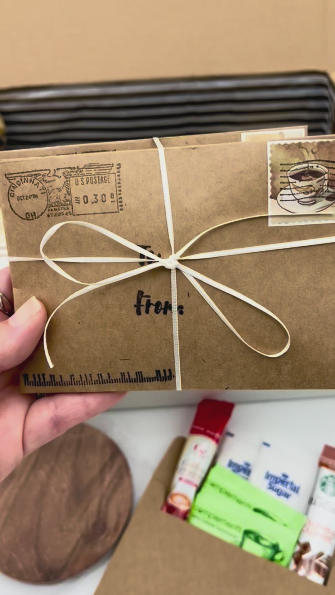 Video showing the assembly of the Week of Coffee Breaks Gift Box with the envelope bundle being placed inside, followed by a full view of the coffee gift box and ending with a disposable cup being filled with fresh coffee